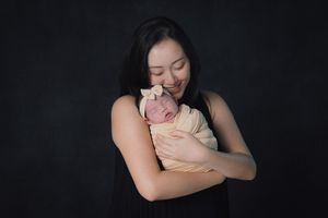 Artistic studio portrait with dramatic black background.