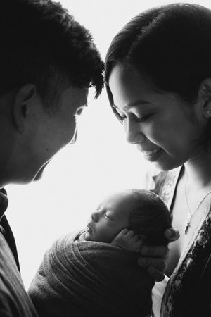 Intimate black and white silhouette series capturing tender family moments.