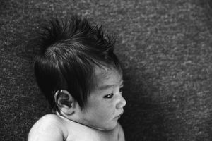 Black and white portrait series showing different angles of a newborn baby's features.