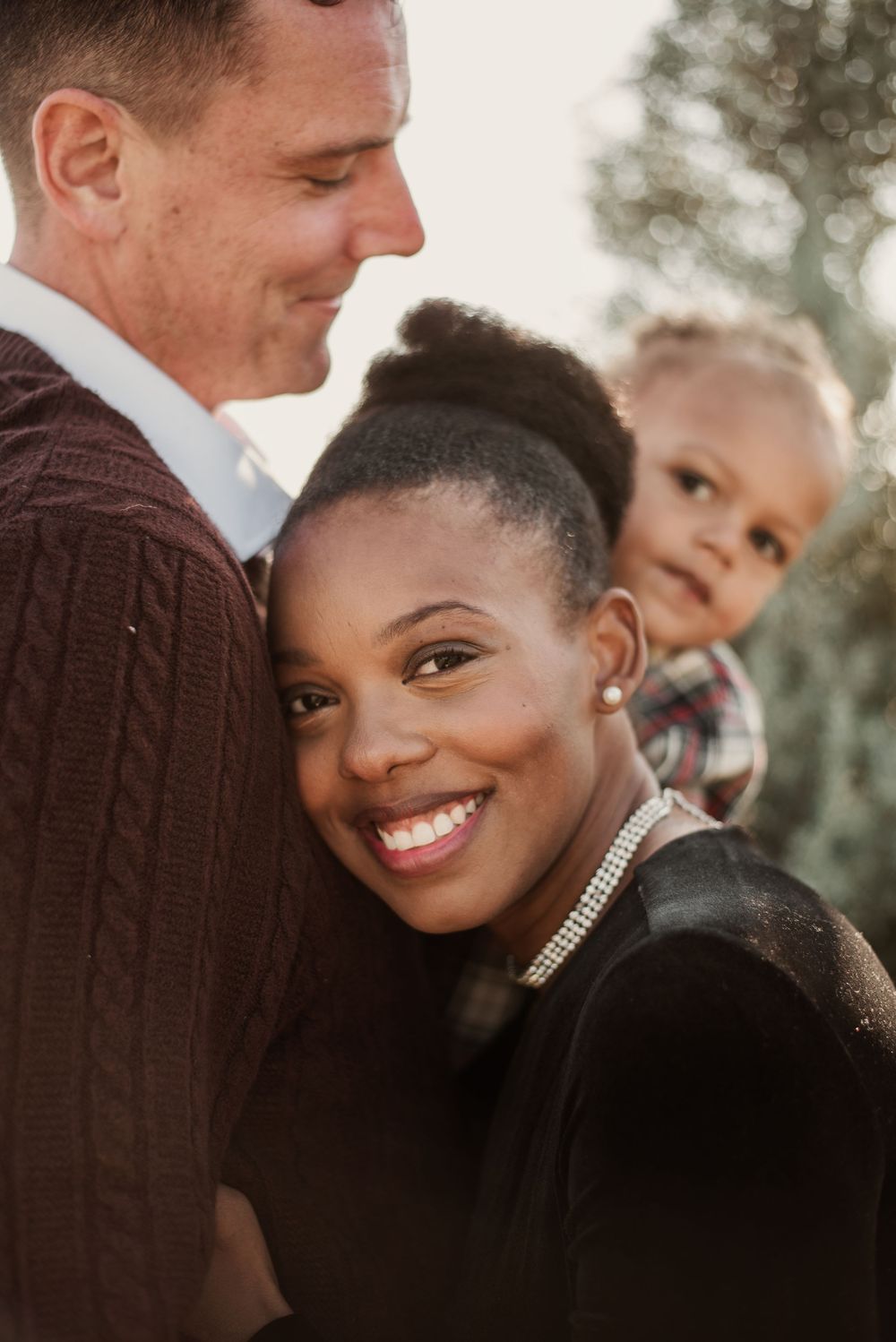 A romantic sequence of close-up shots showing a couple sharing tender moments and smiles outdoors.