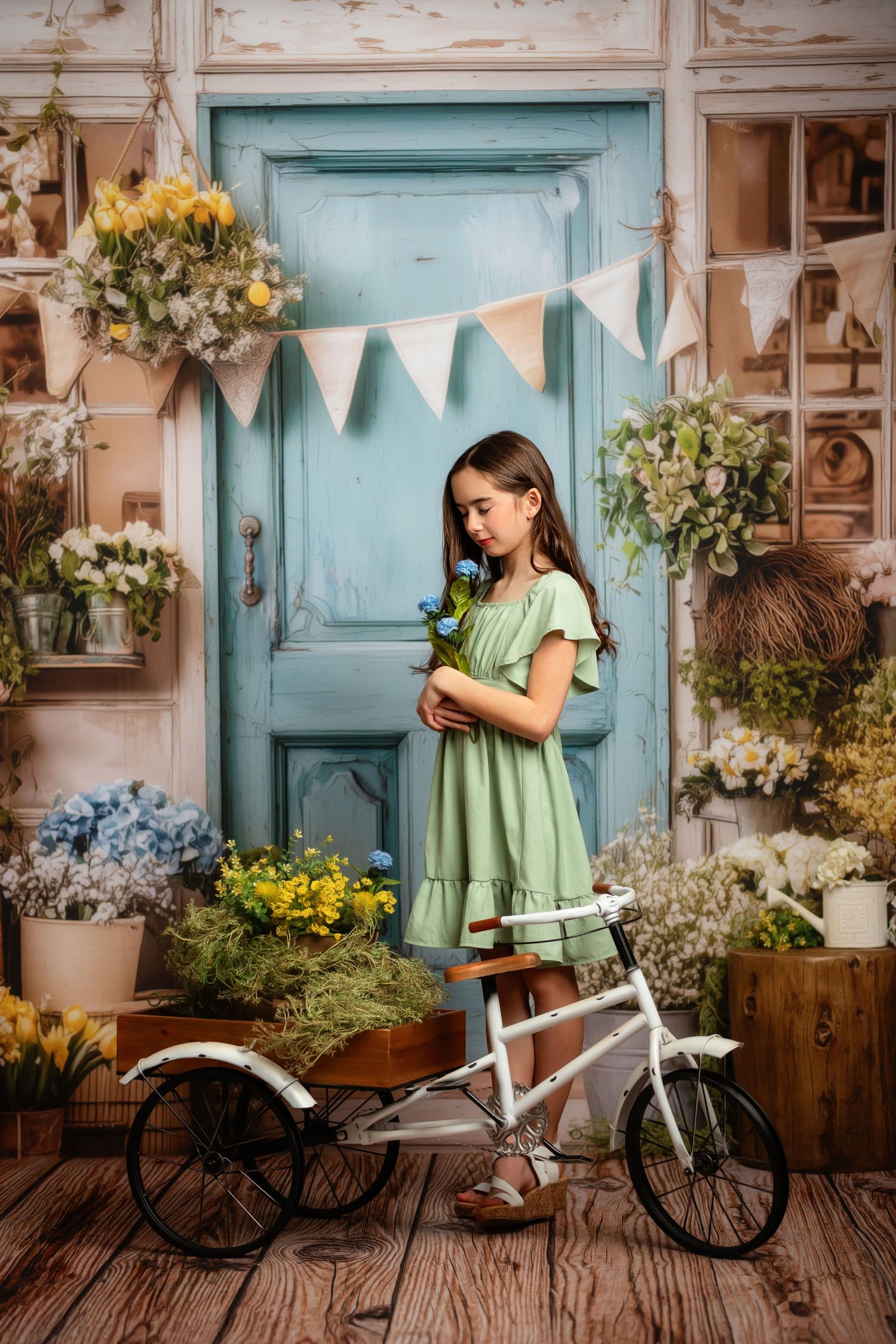 Easter spring photo setup with vintage orange truck, garden backdrop, and baby sitting in rustic wooden basket.