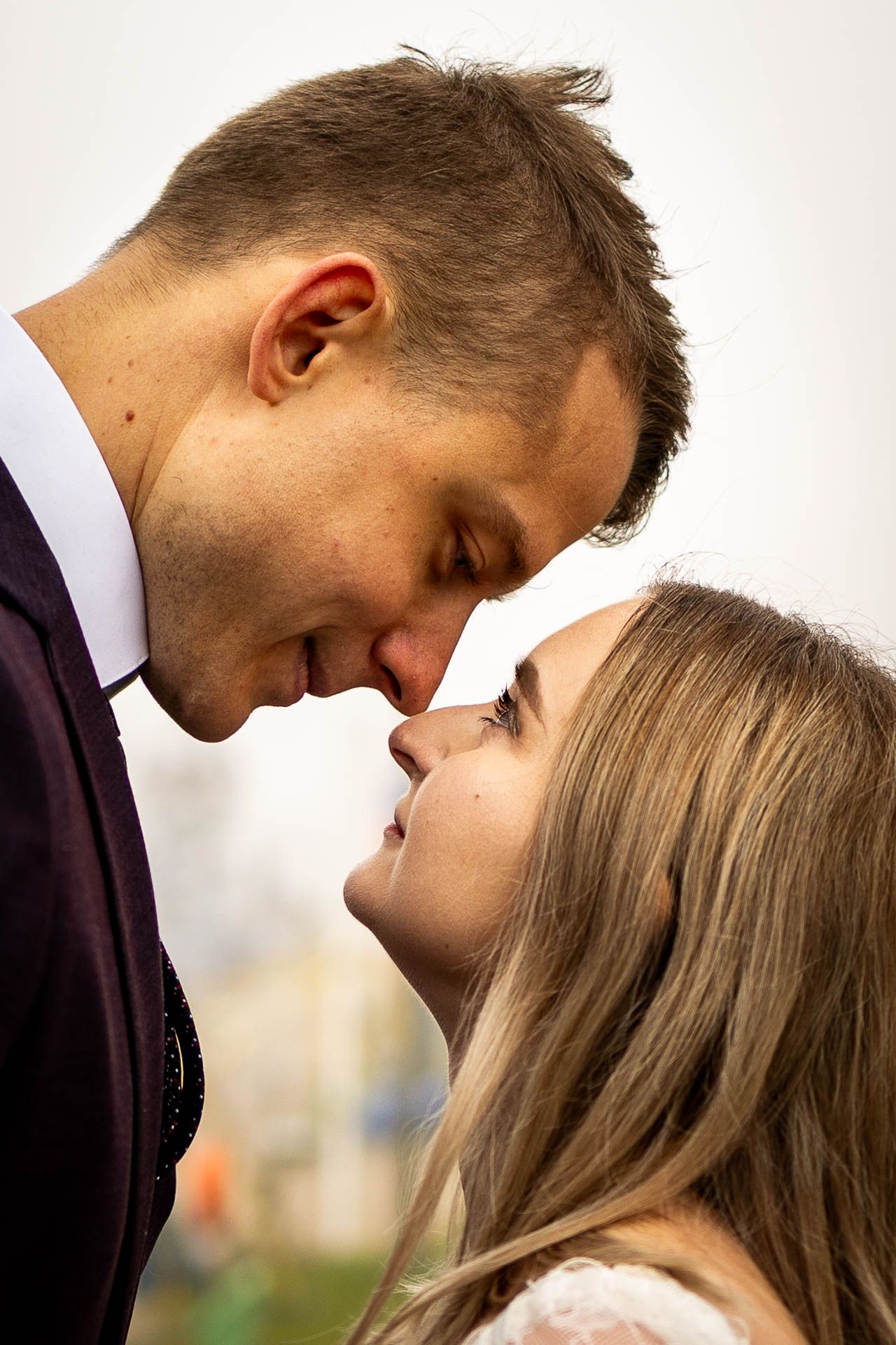 A tender romantic moment between a couple in formal attire.