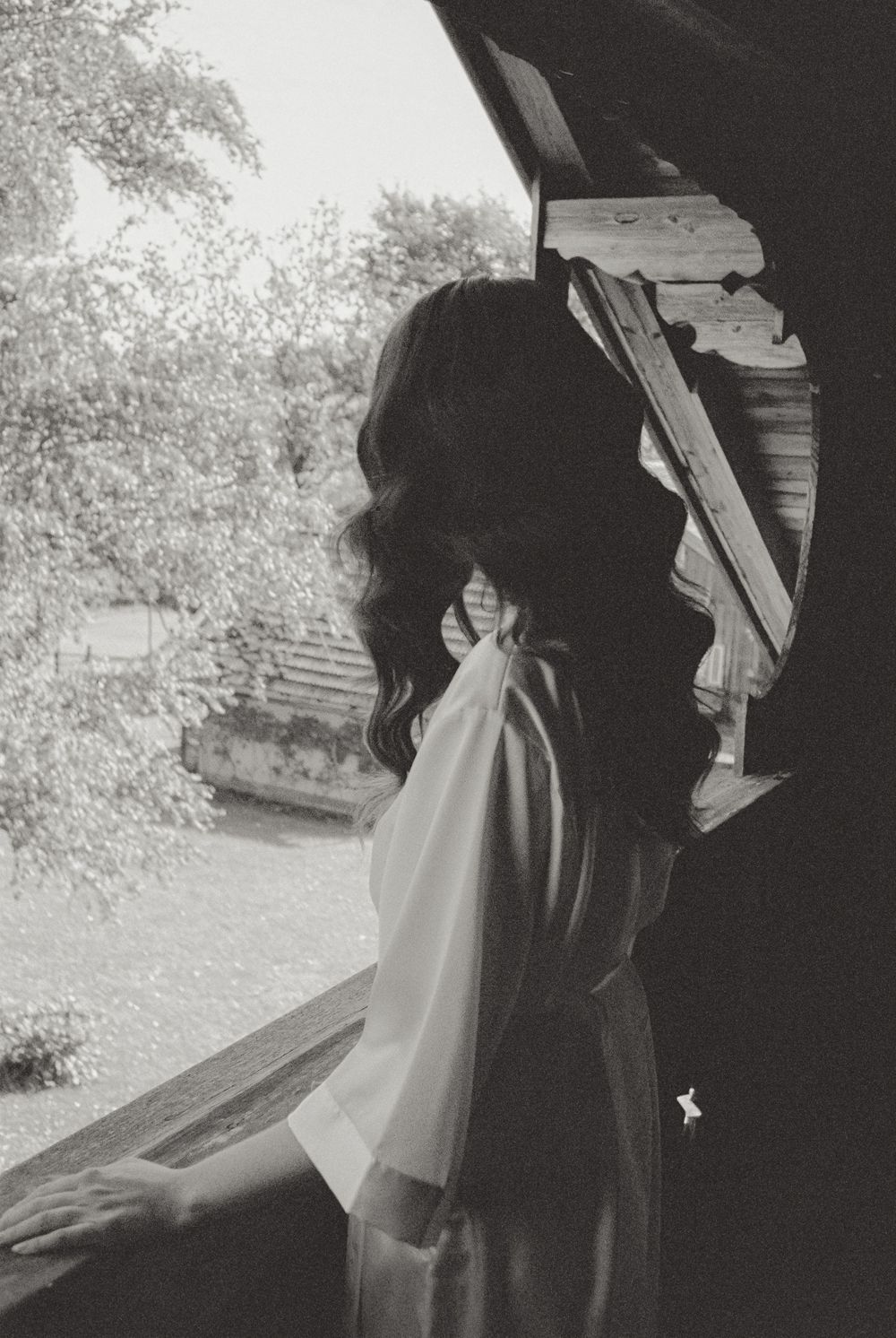 Black and white film wedding photograph capturing an intimate and emotional moment.