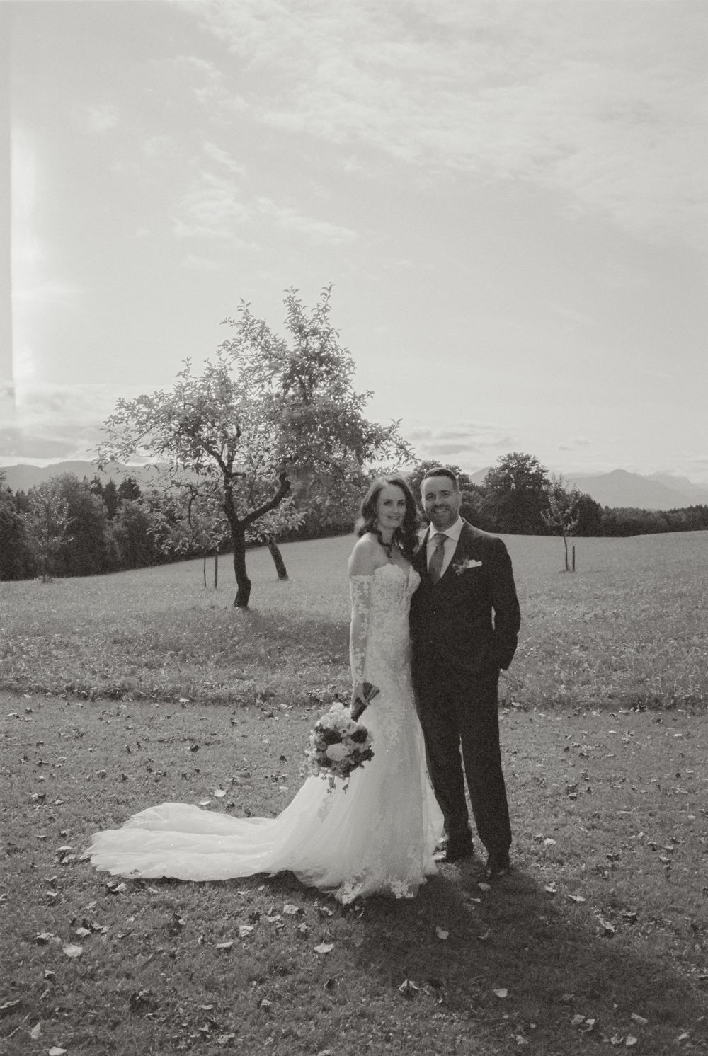 Black and white film wedding photograph capturing an intimate and emotional moment.