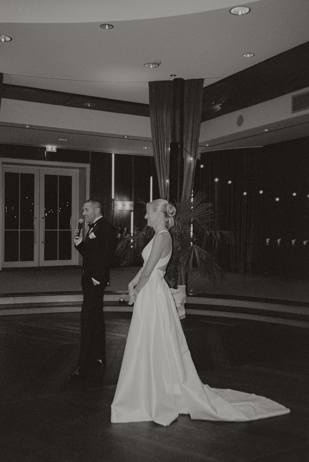 Black and white film wedding photograph capturing an intimate and emotional moment.