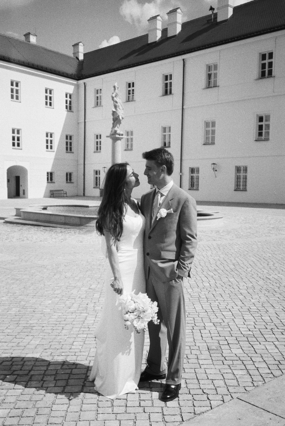 Black and white film wedding photograph capturing an intimate and emotional moment.