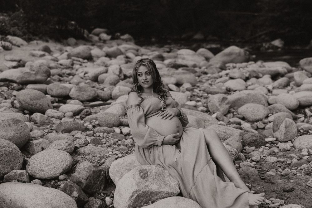 A series of black and white photographs showing people relaxing on rocky terrain near a river or stream.