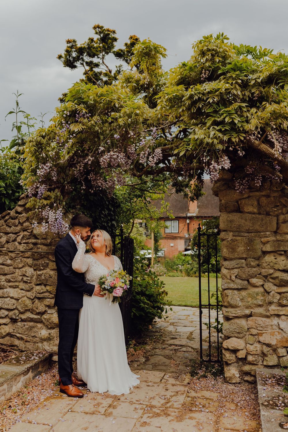 Hannah and Jordan posing for wedding portraits at Montagu Arms, Brockenhurst, Hampshire.