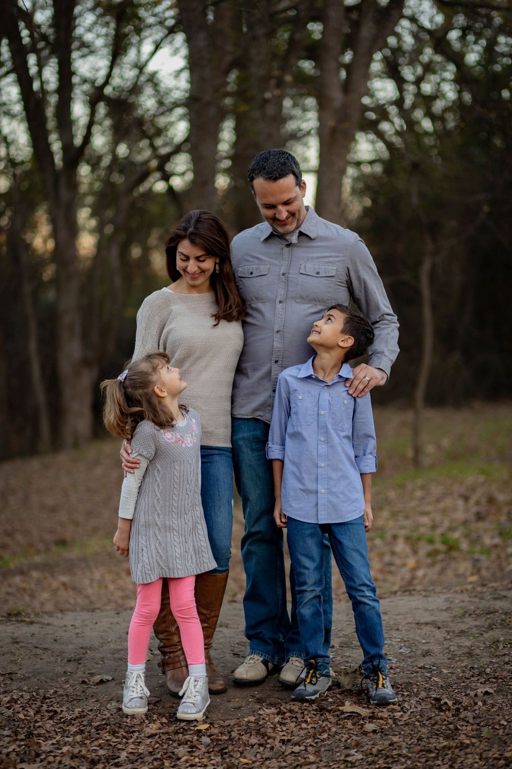 A family posing for a photo in the park.