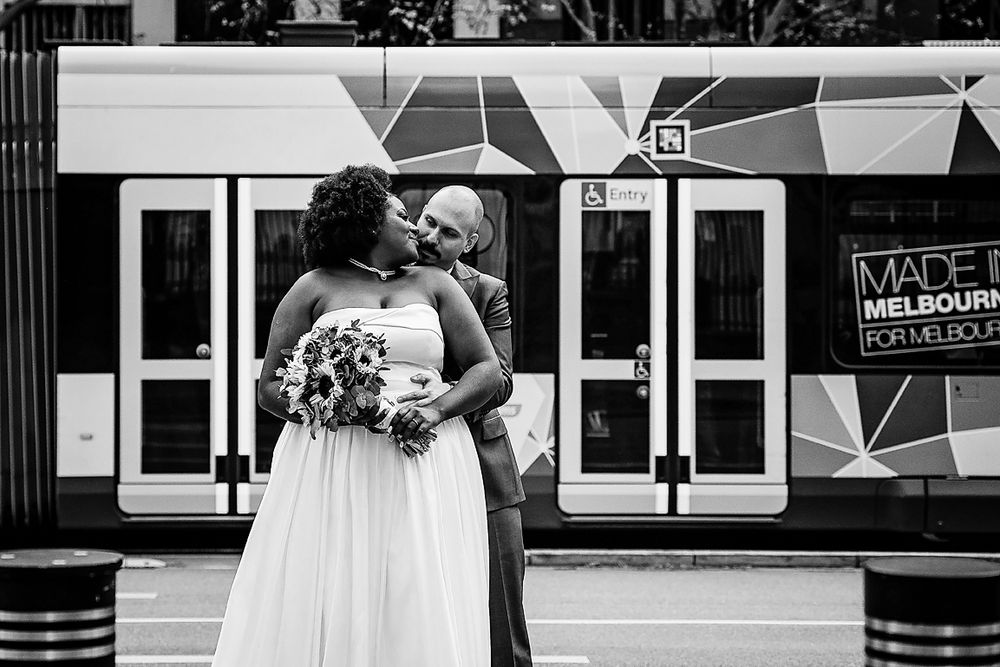 A series of black and white wedding photos displayed in a horizontal strip showing moments between columns.