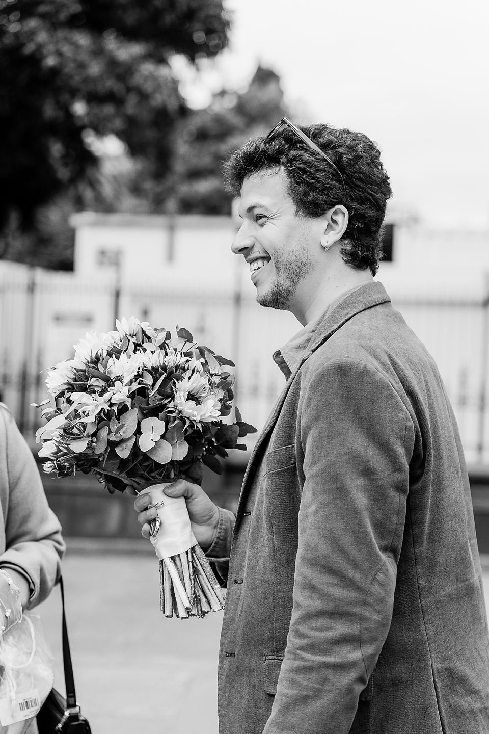 A sequence of black and white photos showing a person in a suit holding a floral bouquet.