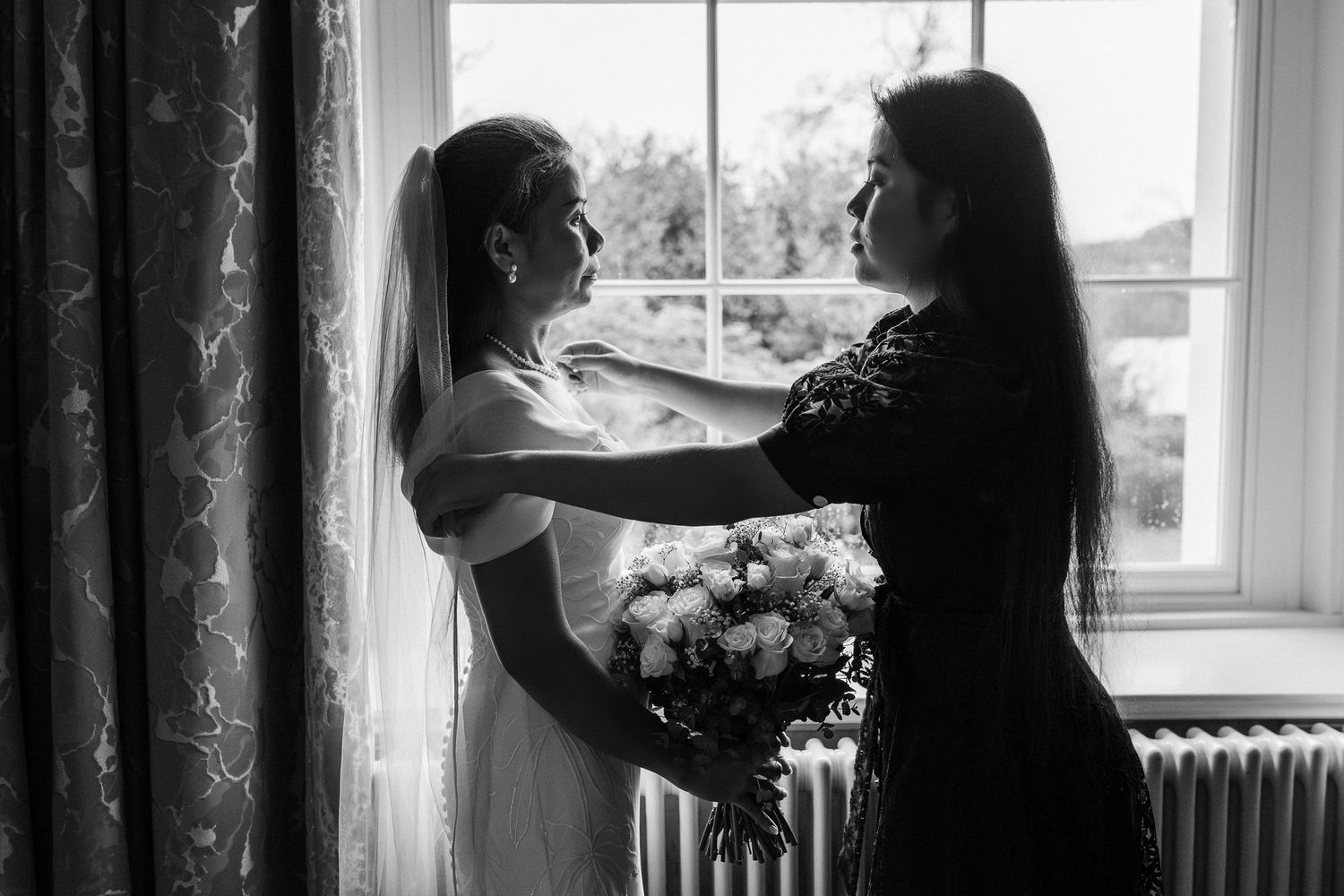 A black and white photo series showing people dancing in a room with windows and curtains.