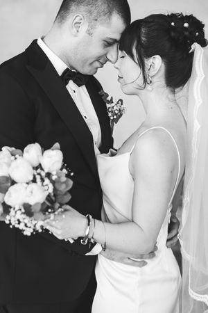 A series of romantic black and white wedding photos showing intimate moments between the bride and groom.