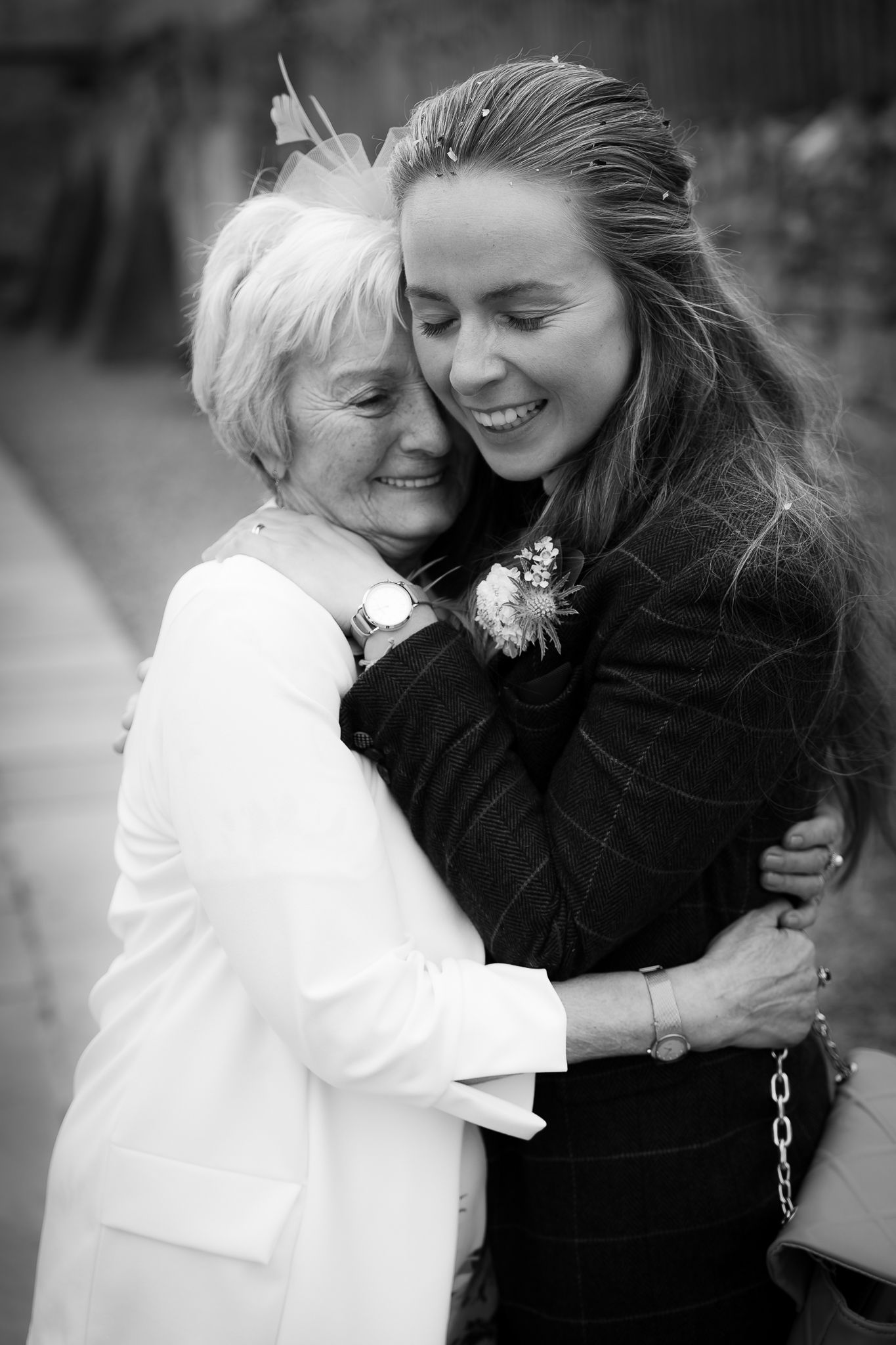 Series of black and white photos capturing tender embraces and shared laughter between two people.