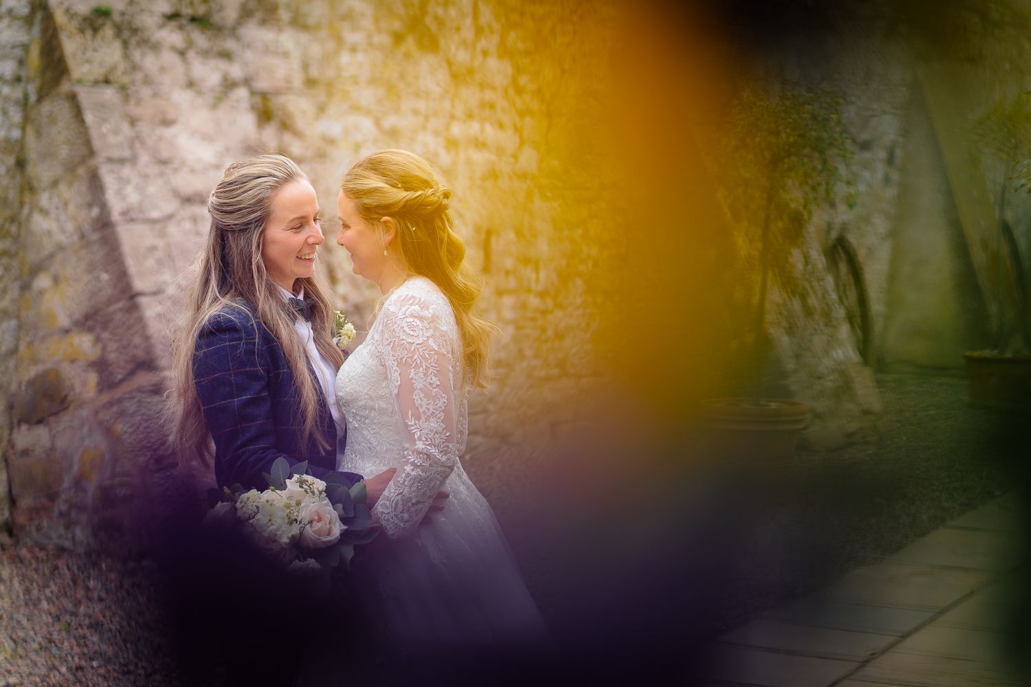 Warm-toned artistic wedding photos with romantic lighting effects.