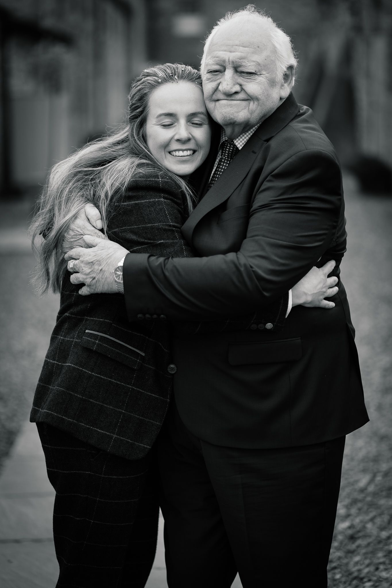 Black and white sequence showing heartfelt hugs and genuine moments of connection.