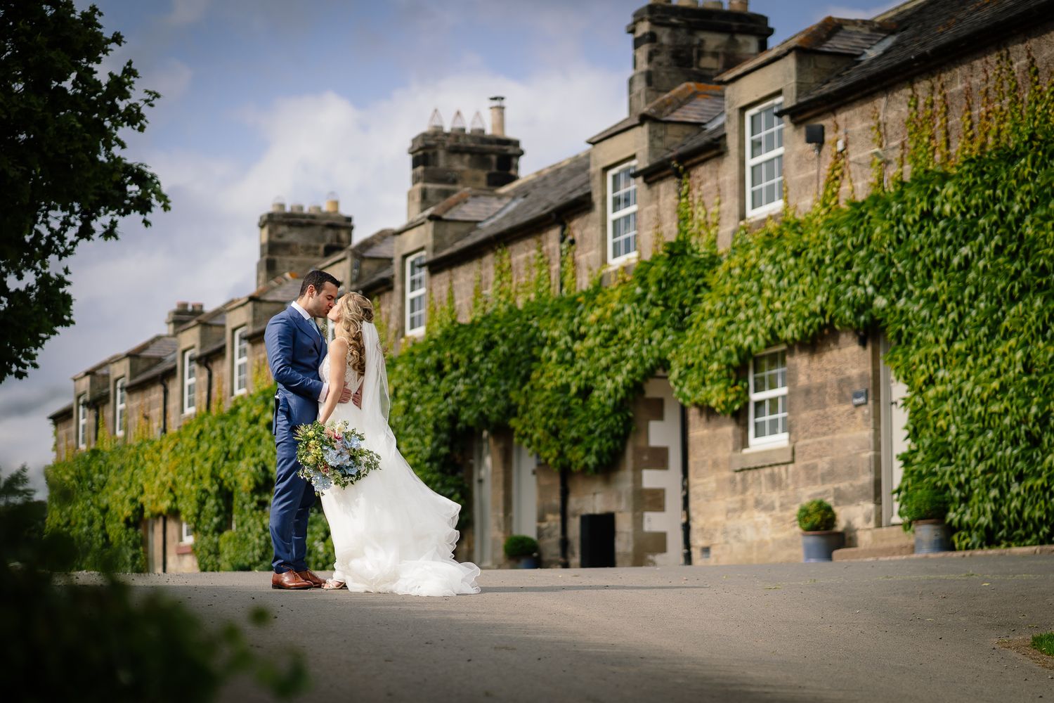 Stone building exterior with ivy-covered walls and traditional architecture. Doxford Barns