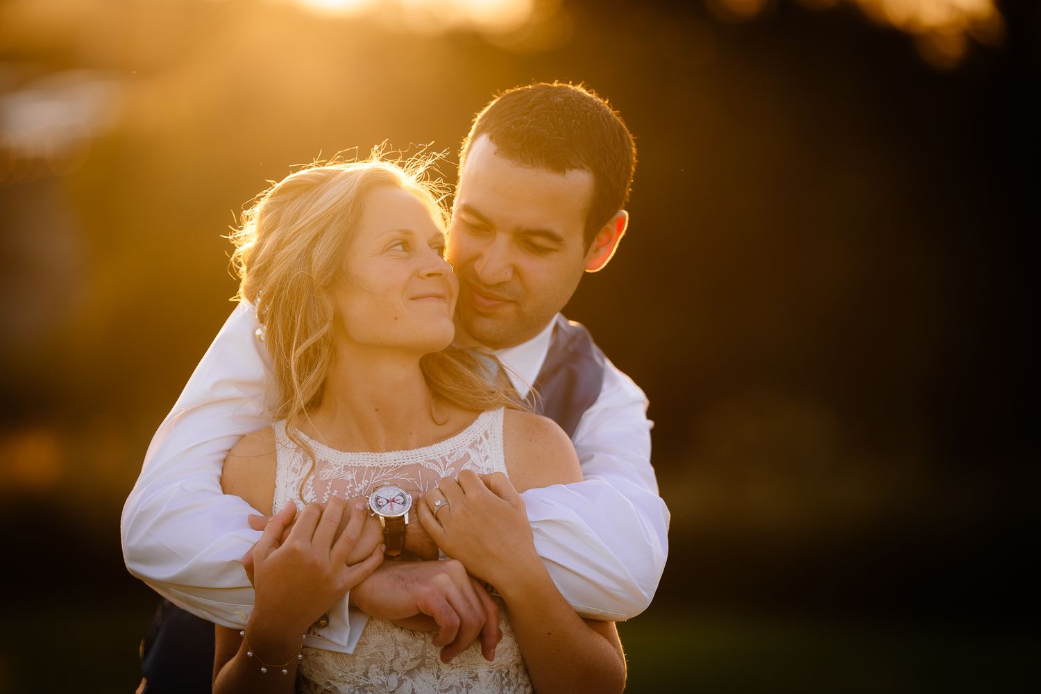 Golden sunset silhouette of couple embracing in romantic moment. Doxford Barns