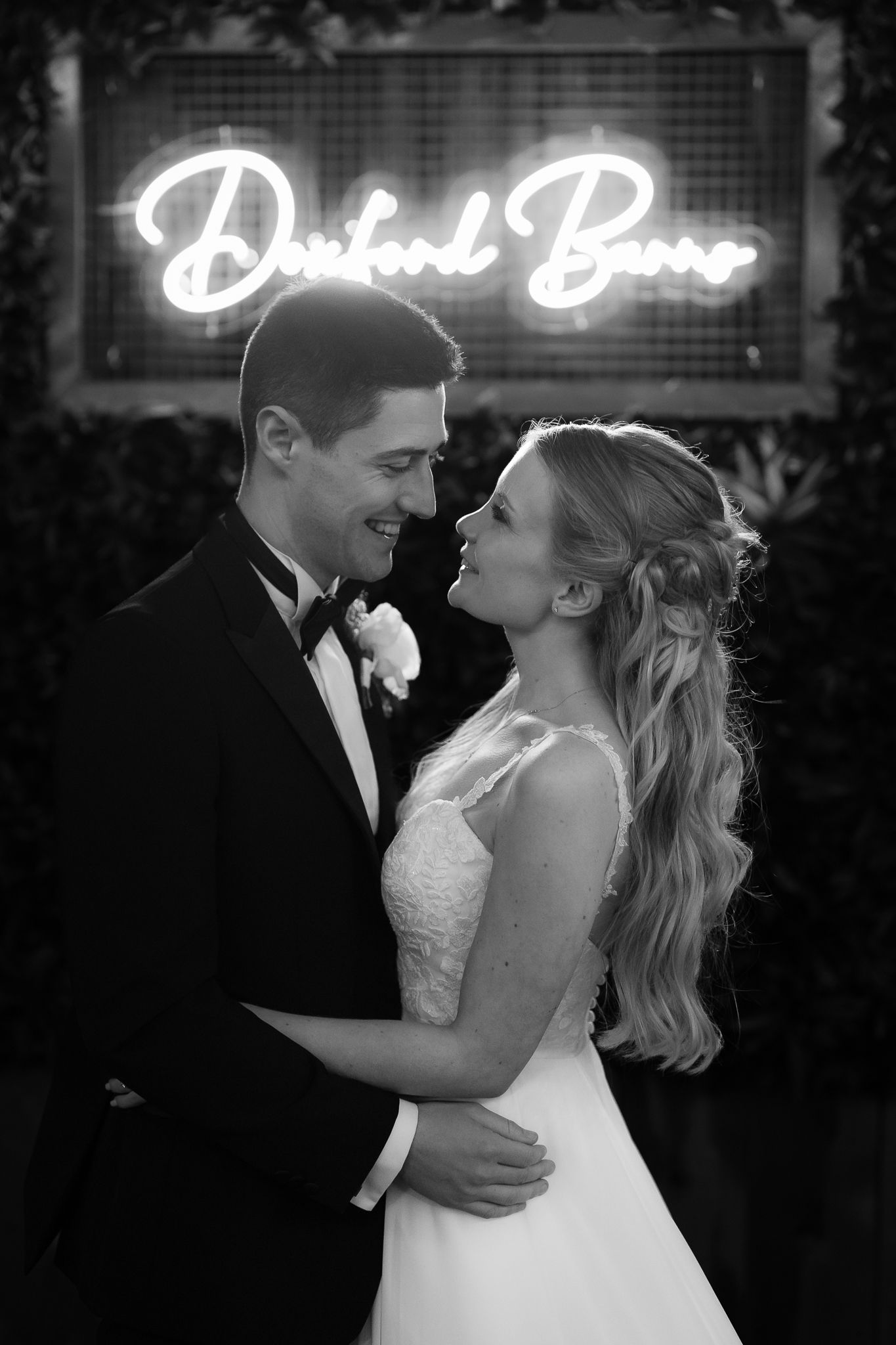 Black and white portrait with glowing neon sign creating romantic atmosphere. Doxford Barns