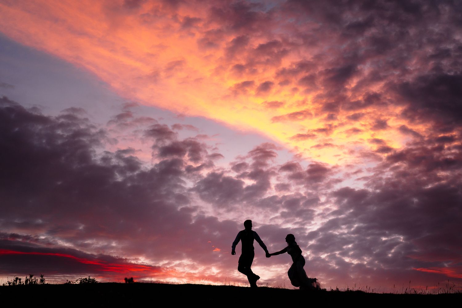 Dramatic purple and orange sunset sky with silhouettes creating a romantic scene.Doxford Barns