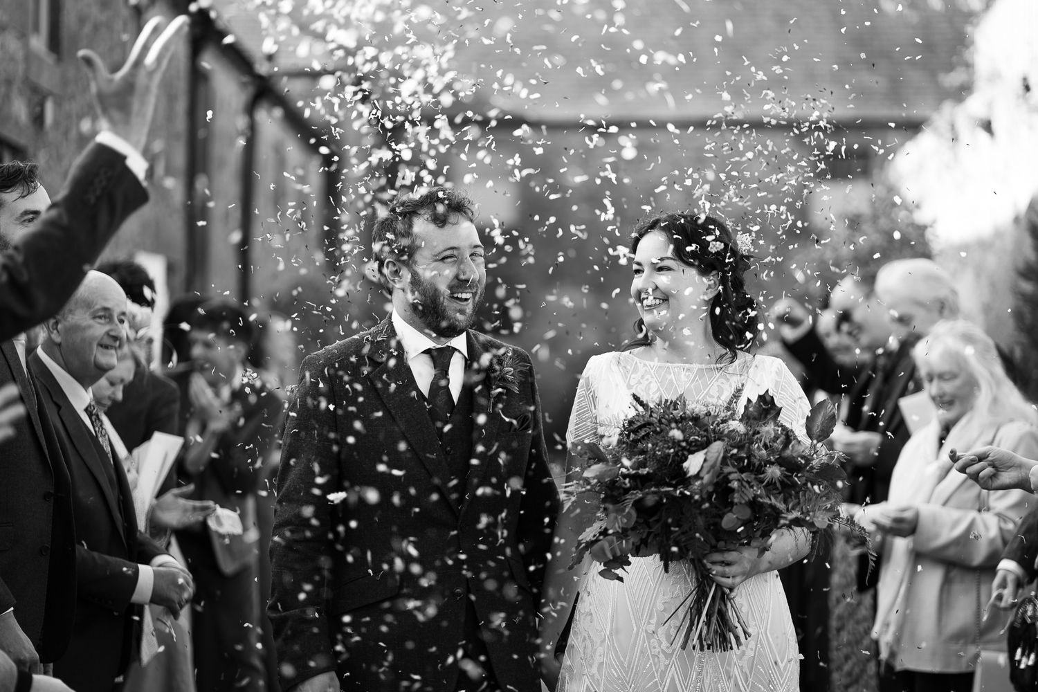 Black and white photo of confetti being thrown during a celebratory moment. Doxford Barns