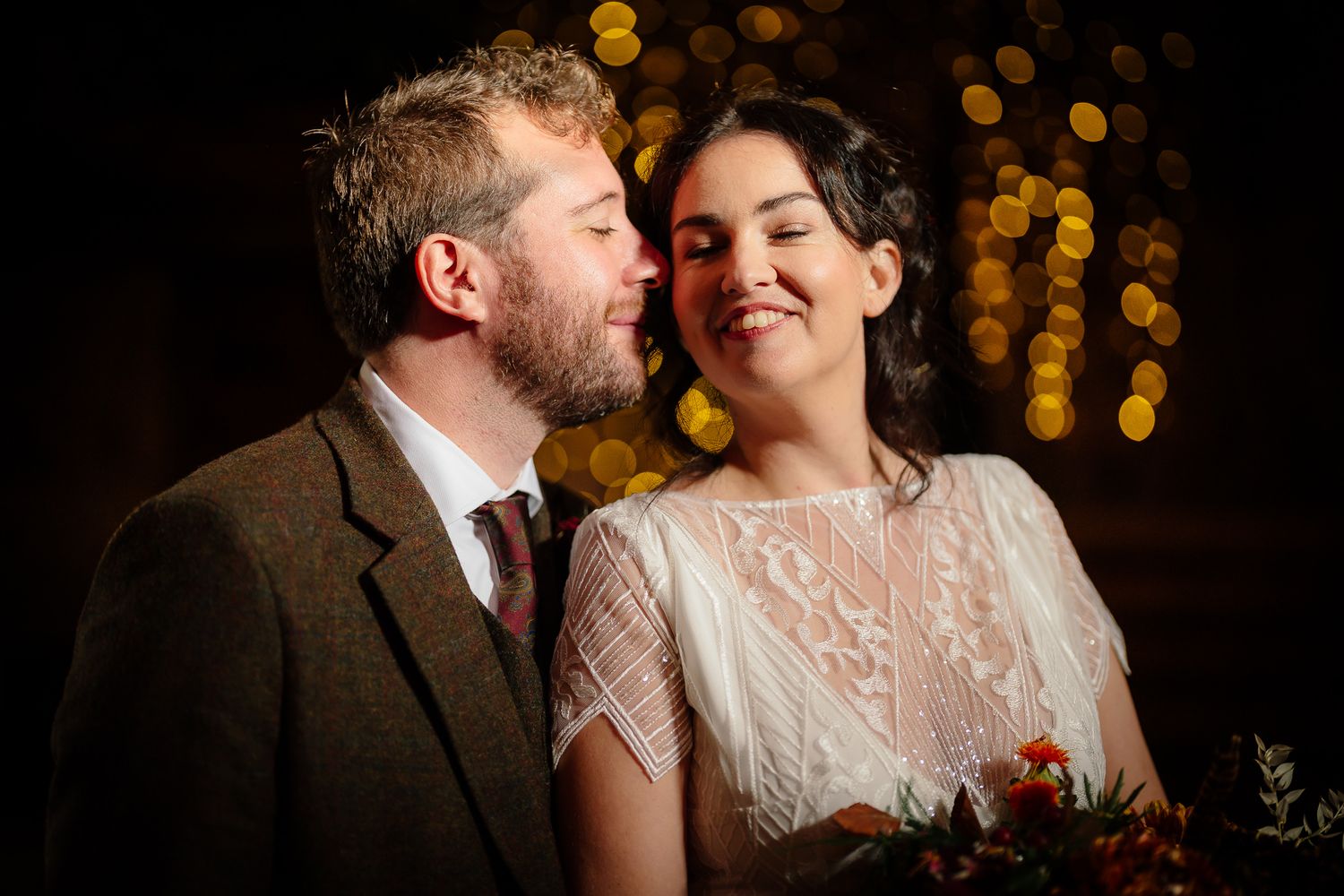 Intimate moment captured with warm bokeh lighting in the background. Doxford Barns