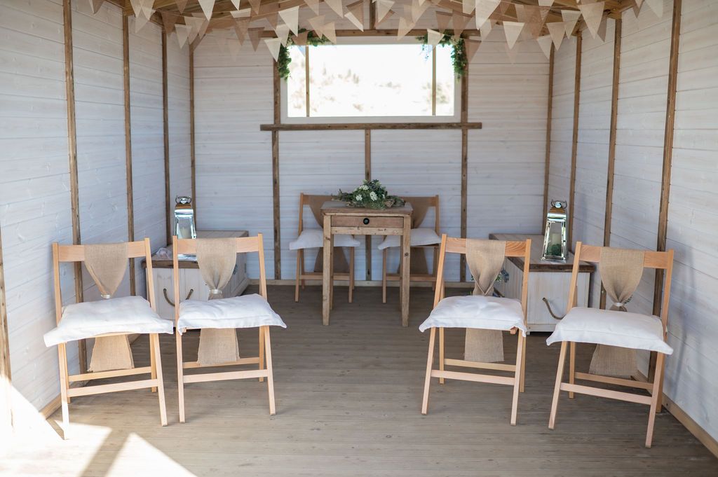 Inside Summerleaze Bude Beach Hut, set up for a wedding with hessian decorations and bunting
