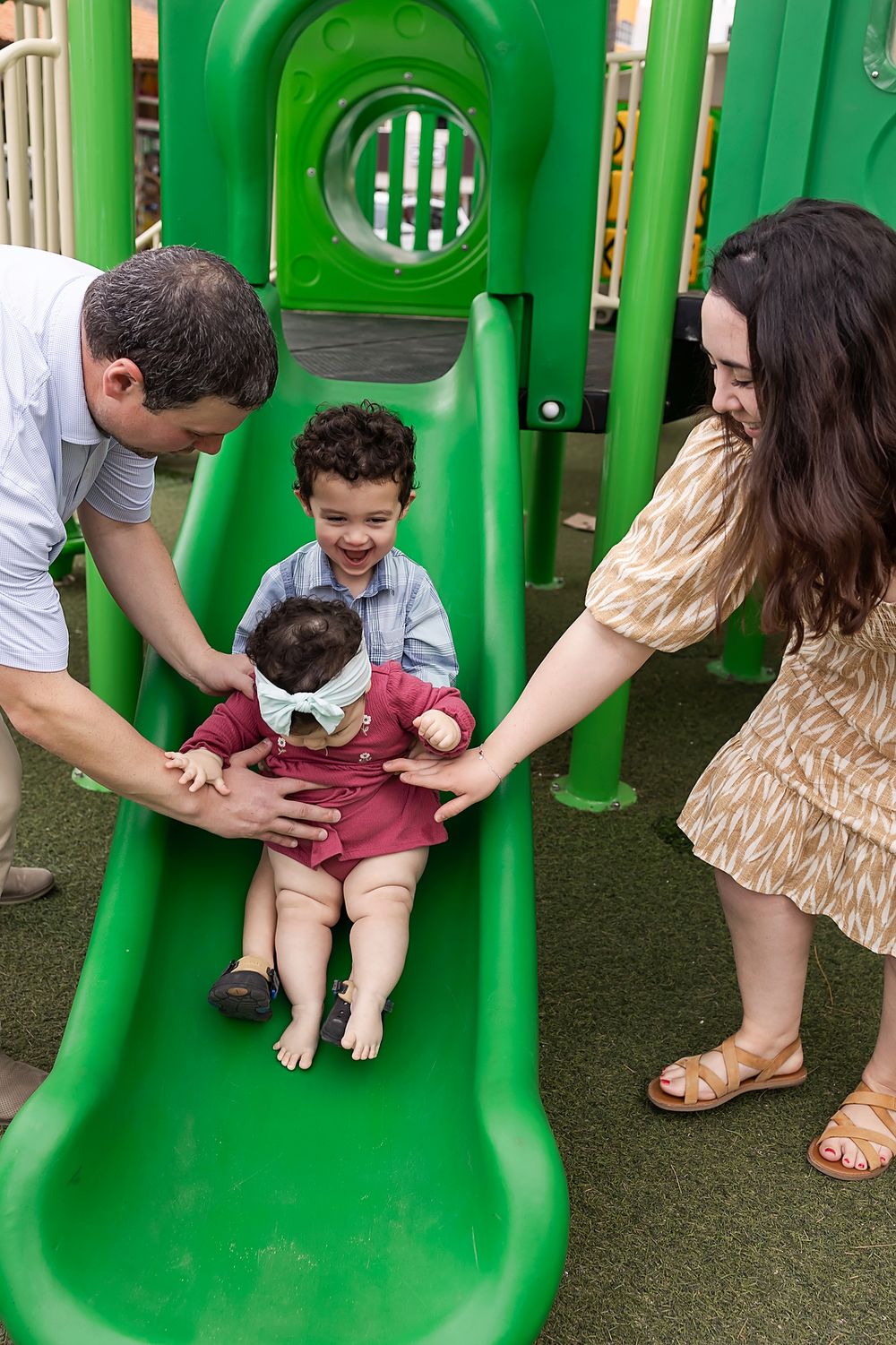 A sequence of photos showing a child being helped down a bright green playground slide by adults.
