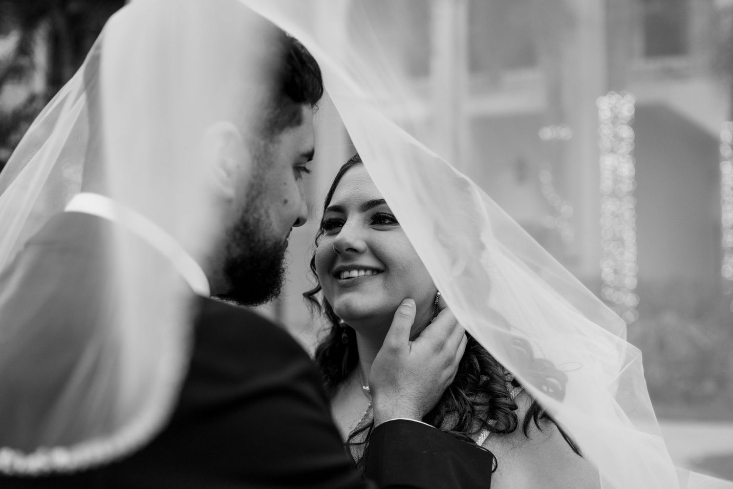 Black and white wedding photo collage showing intimate moments between a couple during their celebration.