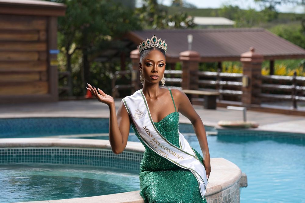 Pageant contestant in sparkling green dress and sash poses elegantly by swimming pool.