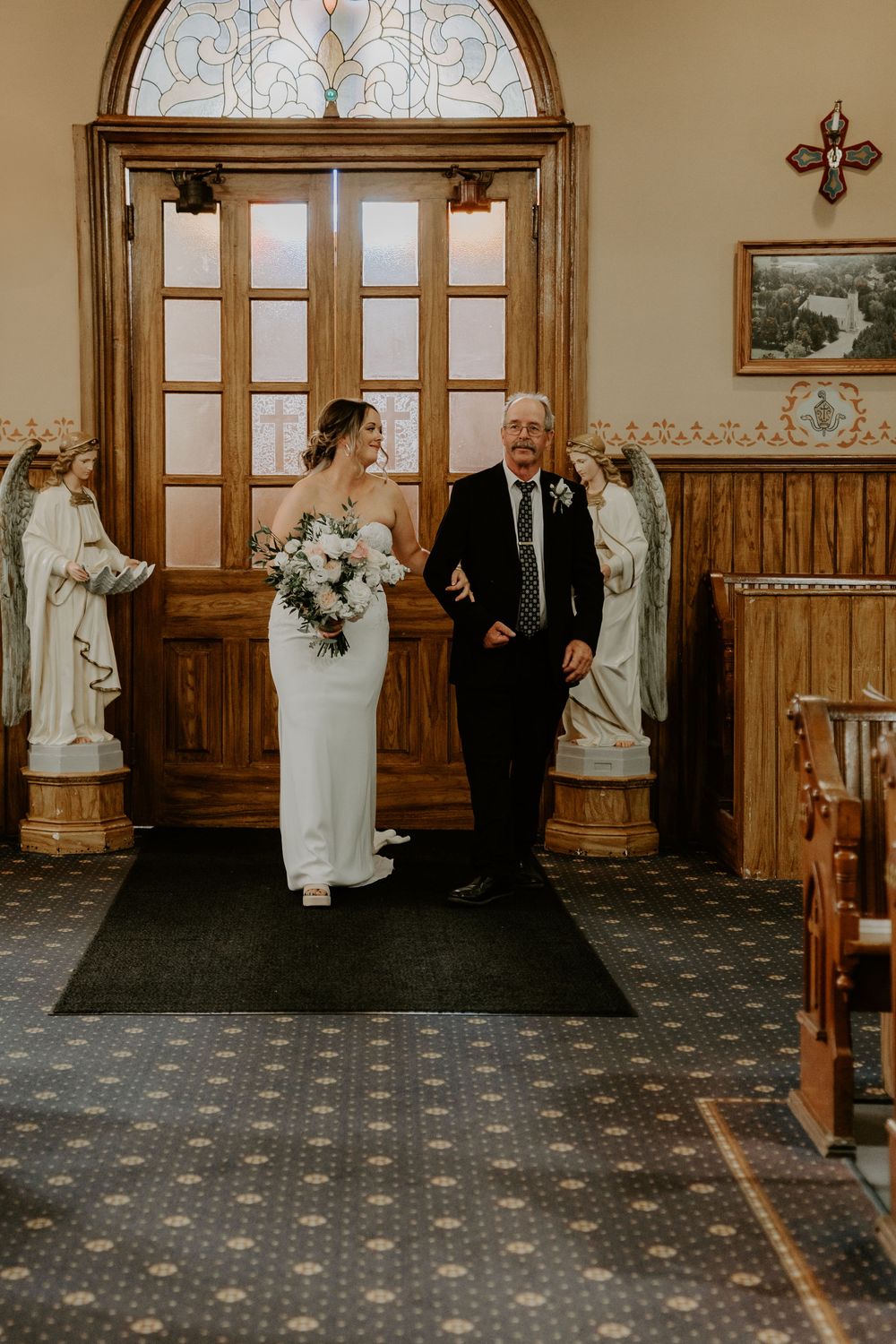 bride enters church with father