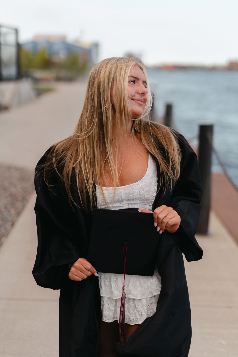 A series of candid photos showing someone in a black sweater and white top walking along a waterfront path.