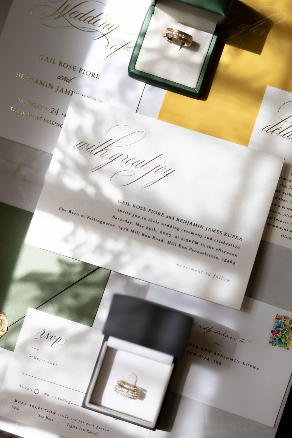 Elegant wedding invitation suite with white stationery cards and envelopes arranged in a flat lay composition.