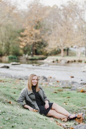 A series of outdoor portrait photos showing someone lying on autumn leaves in a park setting.