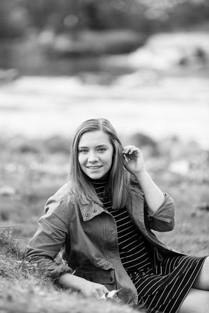 Black and white portrait series showing relaxed outdoor poses in casual fall attire.