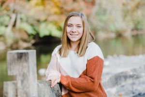 Autumn outdoor portrait series featuring warm sweaters and natural lighting.