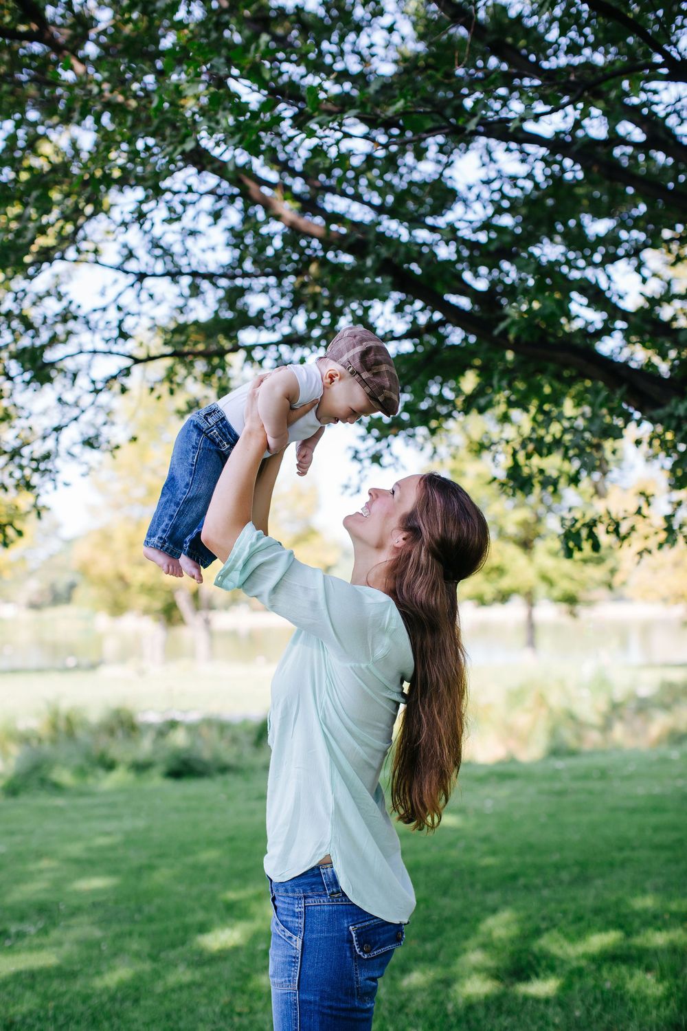 A playful moment captured in a grassy field with trees in the background.