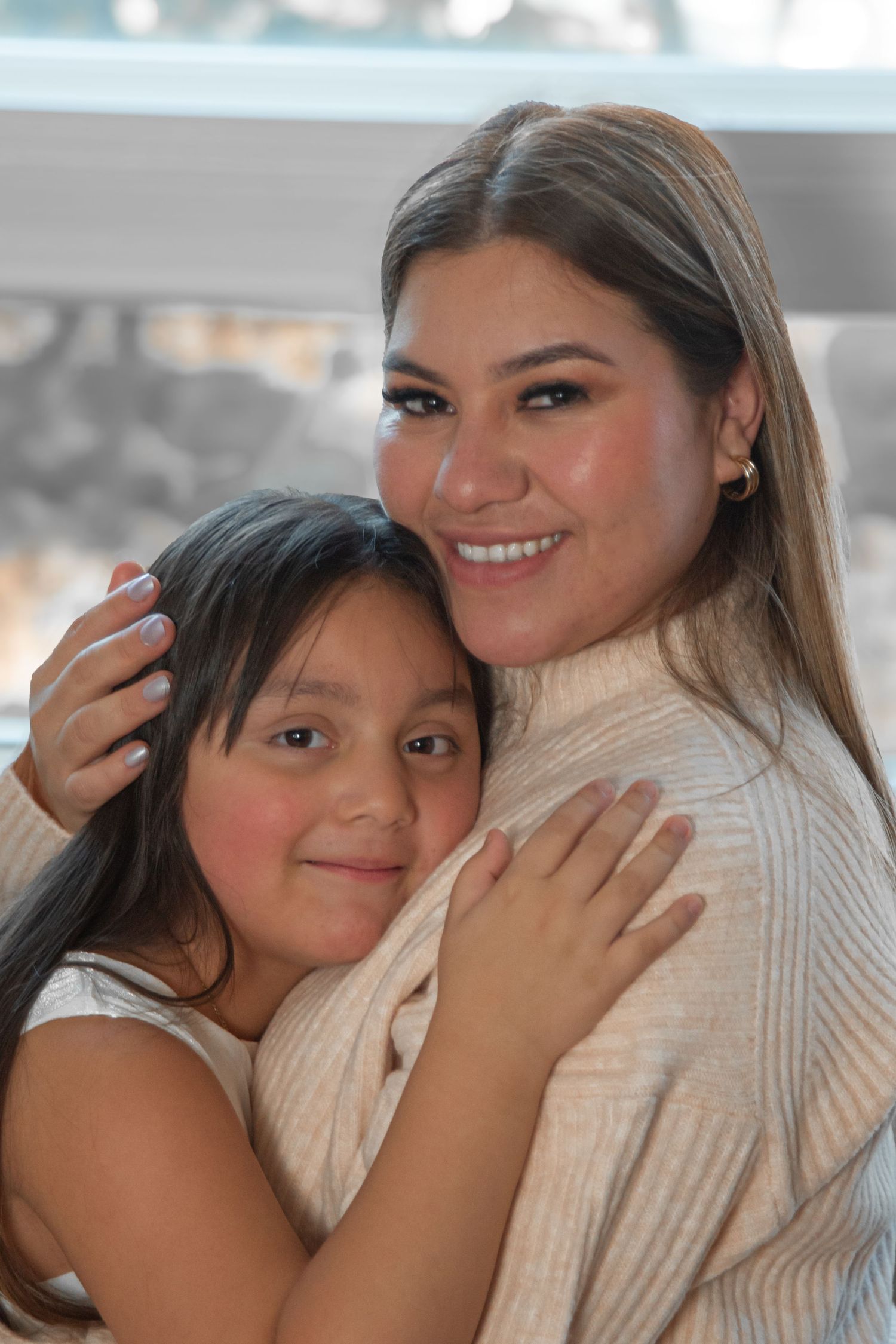 A heartwarming series of photos showing a mother and daughter embracing and sharing joyful moments together.