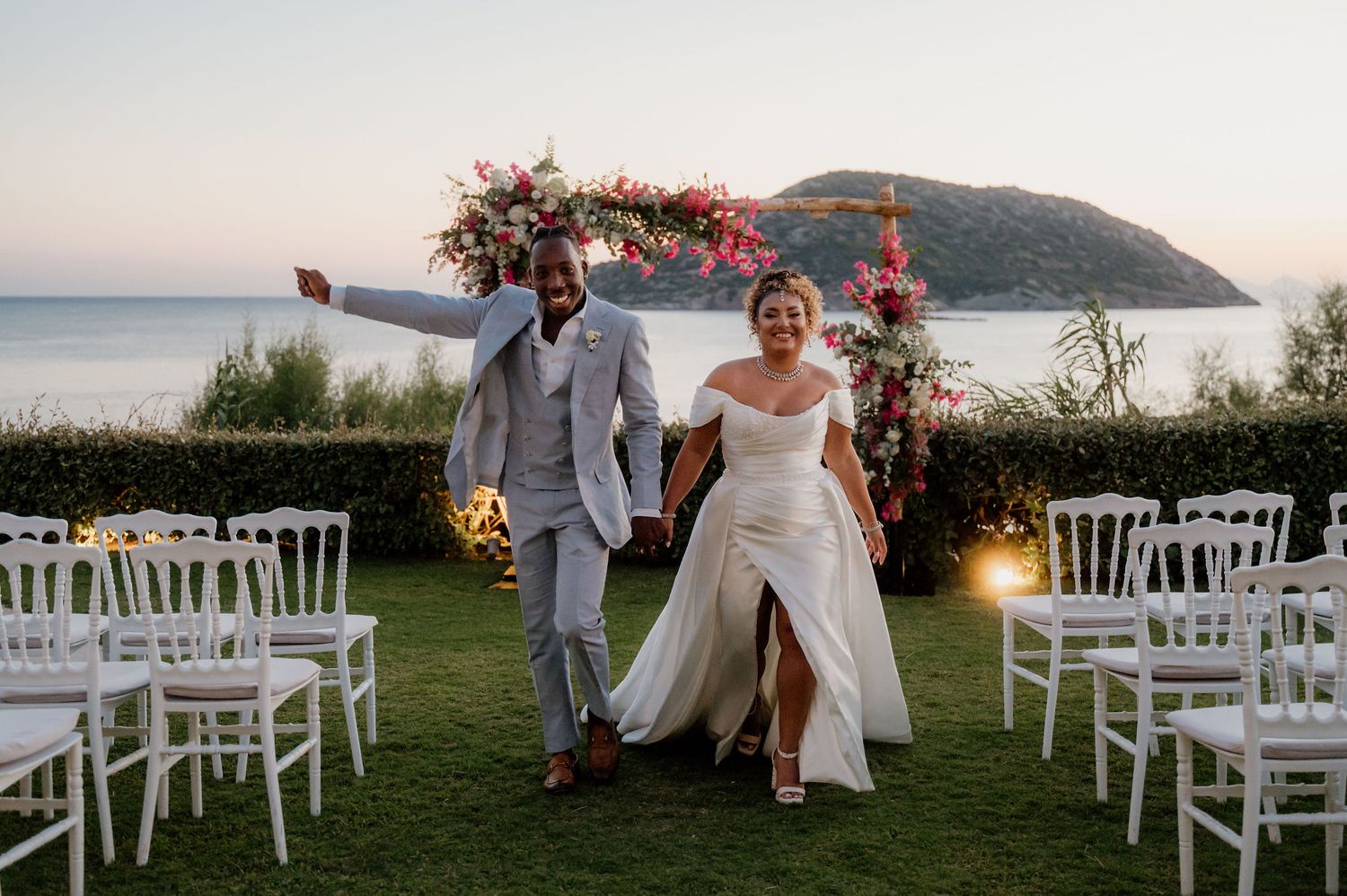 A candid photo of a black couple's exit after their wedding ceremony at Ktima 48 in Athens riviera Greece