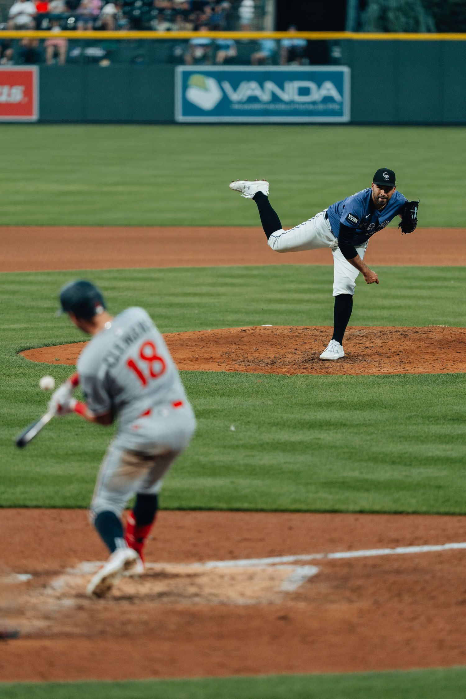 A baseball pitcher shown in a sequence of motion frames delivering a pitch from the mound during a game.