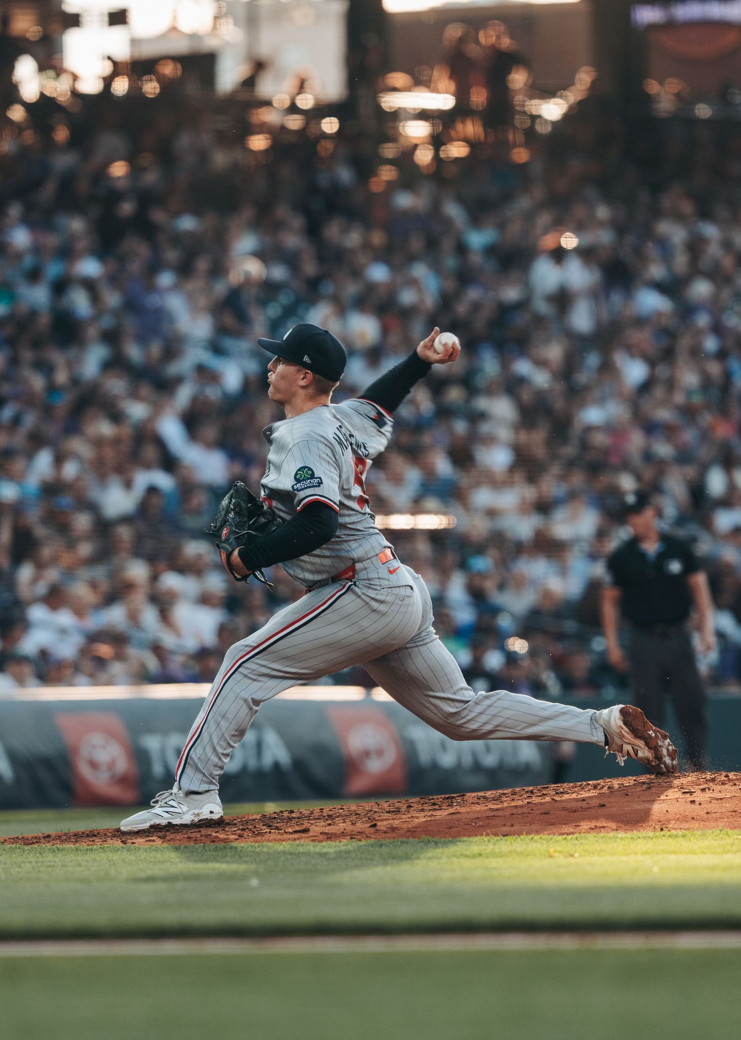 Baseball pitcher in mid-delivery motion shown in multiple sequential frames capturing their throwing mechanics.