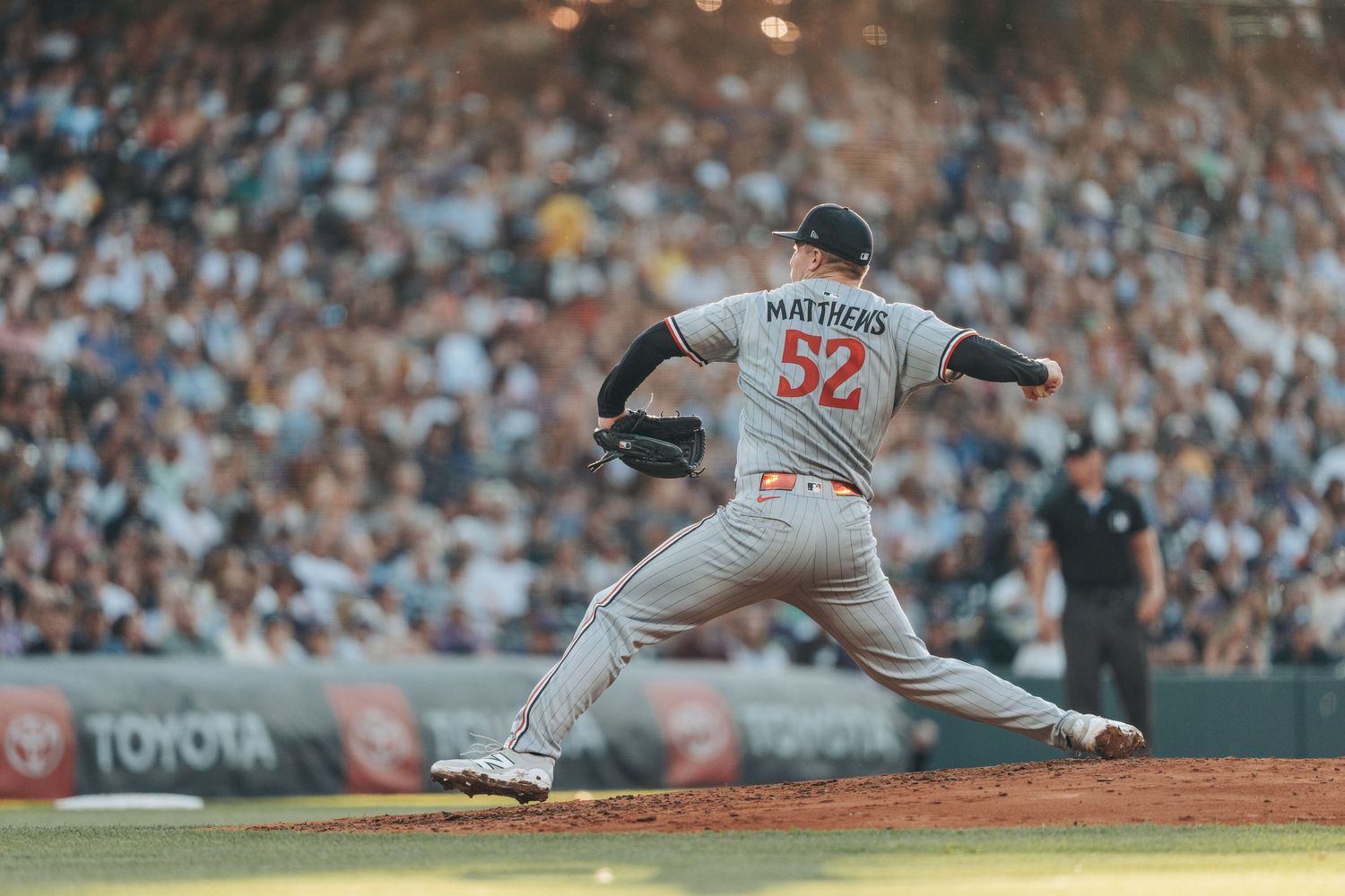 Baseball pitcher in gray uniform delivers pitch with dynamic follow-through motion across multiple action frames.