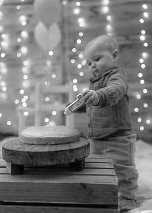 Progressive shots of a small child interacting with a wooden surface against twinkling lights.