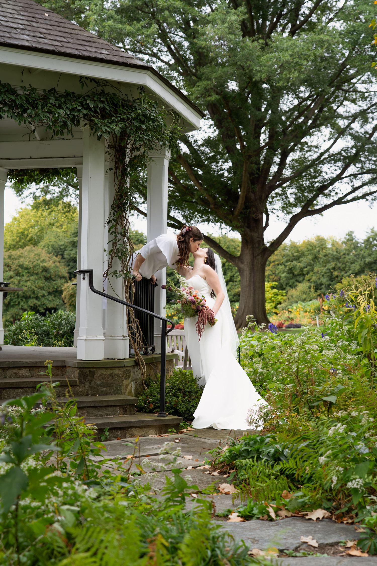 Lesbian couple kissing under a gazebo