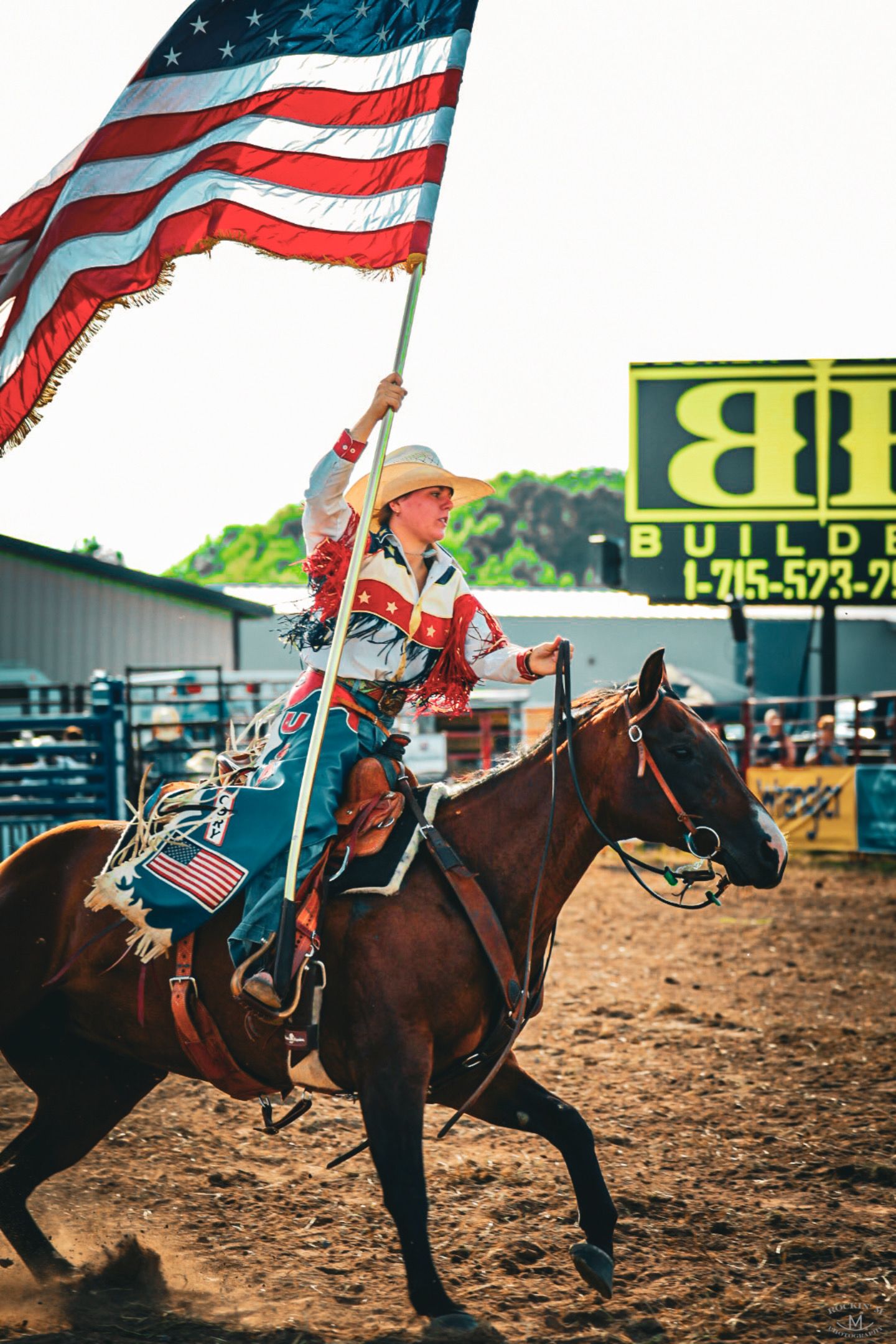 girl on horse carrying flag
