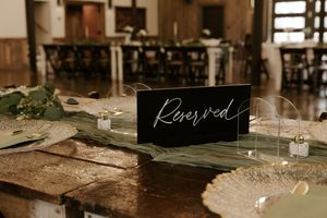 Rustic wooden tables set for a wedding reception with vintage decor and place settings.