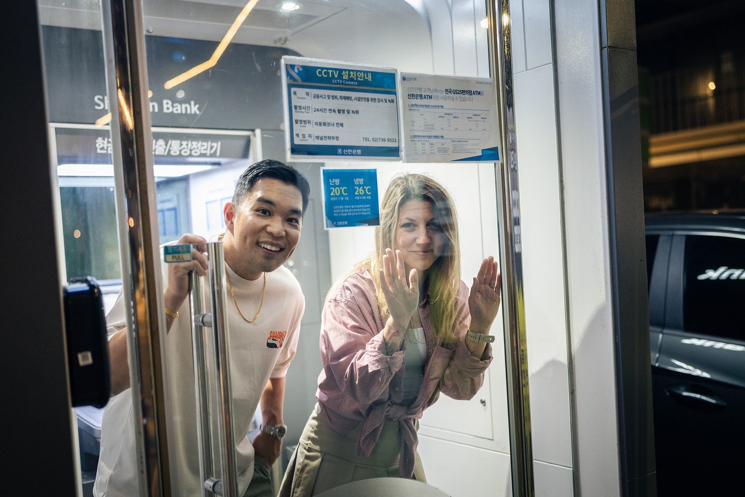 Passengers stand inside a crowded subway car with open doors visible in the background.