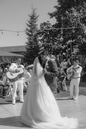 Black and white photo of wedding reception dance with guests in formal attire.
