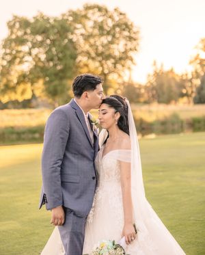A romantic sunset wedding photo session in a grassy field.