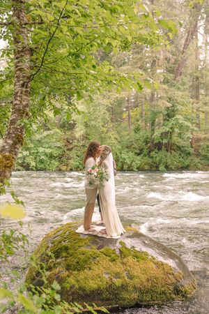 Scenic waterfall and mossy rocks create a dramatic natural backdrop.